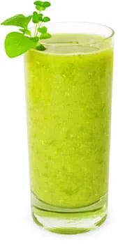 verre rempli d'une boisson verte healthy sur un fond blanc